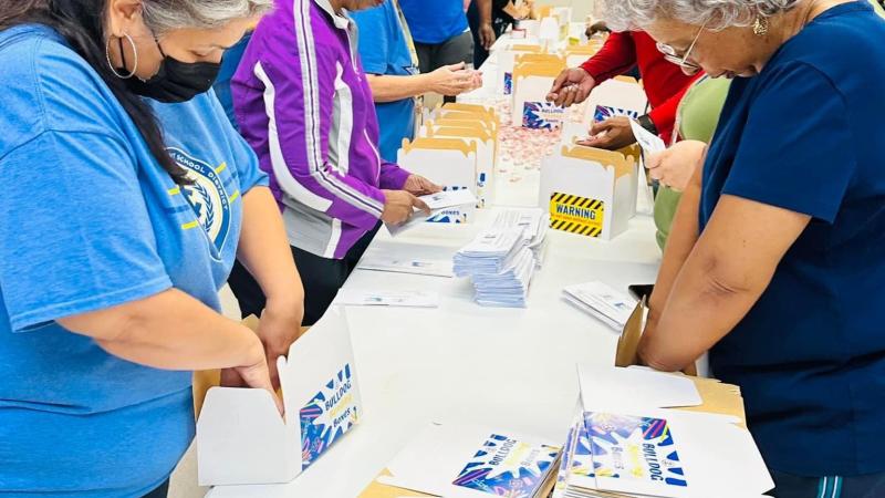Teachers and community members working together to create boxes.