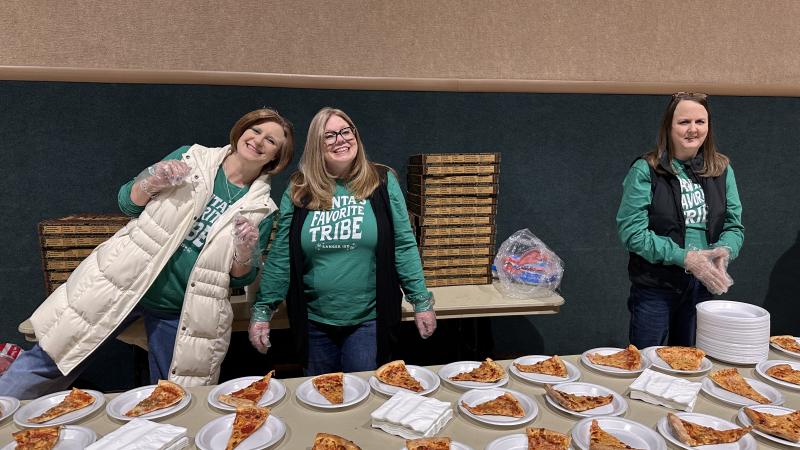 District staff standing at dessert table